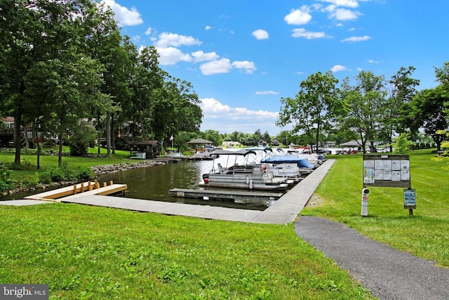 dock area featuring a yard and a water view