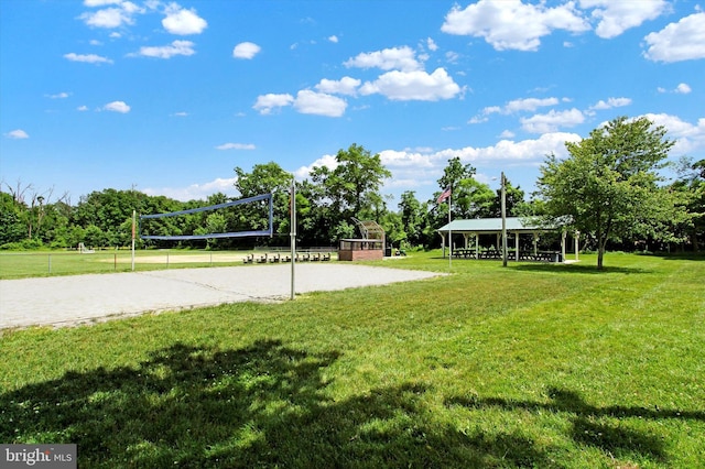 view of property's community with volleyball court, a lawn, and a gazebo