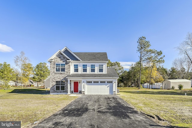 view of front facade with a garage and a front yard