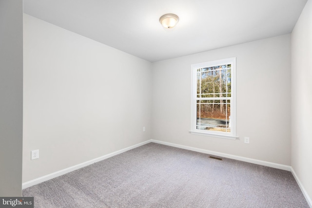 unfurnished room featuring carpet flooring