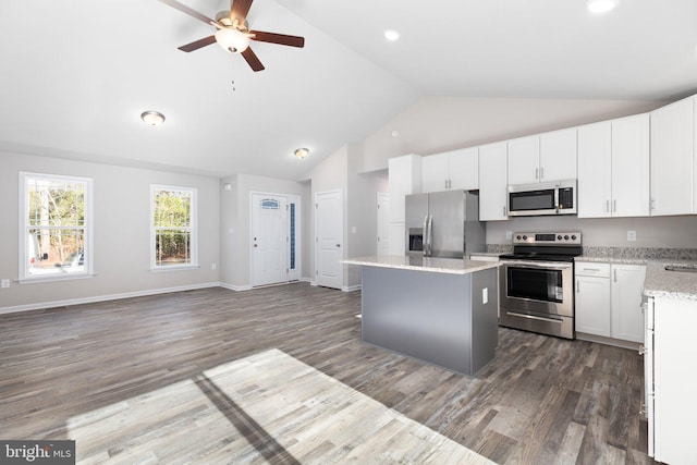 kitchen featuring white cabinetry, a center island, ceiling fan, dark hardwood / wood-style flooring, and appliances with stainless steel finishes