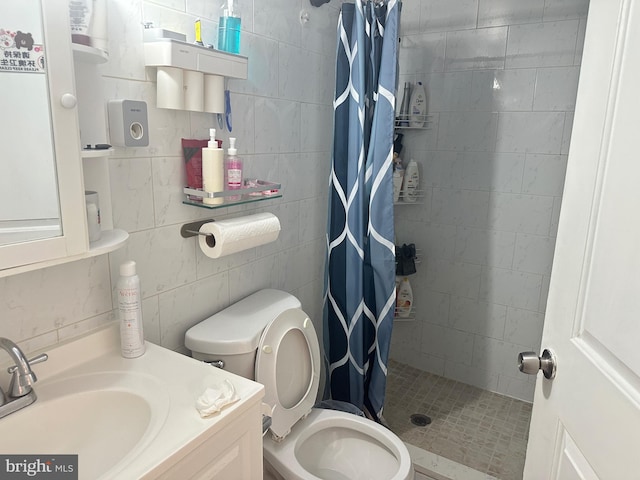 bathroom featuring vanity, curtained shower, toilet, and tile walls