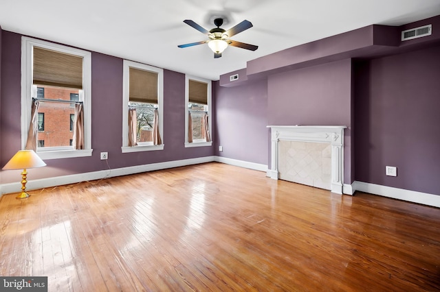 spare room with hardwood / wood-style floors and ceiling fan