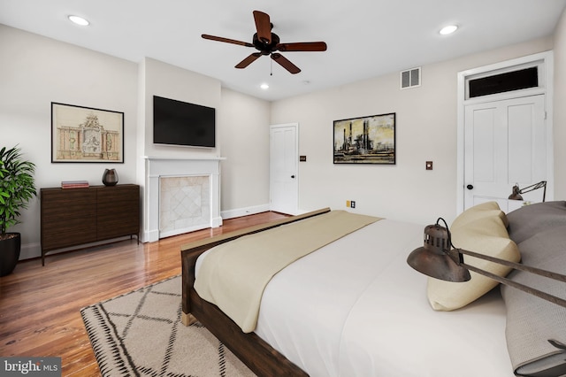 bedroom with hardwood / wood-style floors and ceiling fan