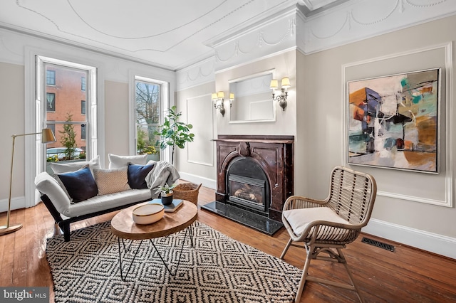 sitting room featuring hardwood / wood-style flooring and crown molding