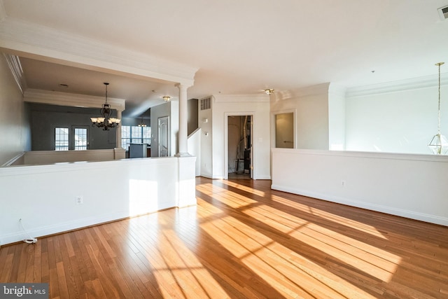 interior space featuring hardwood / wood-style floors, an inviting chandelier, and crown molding