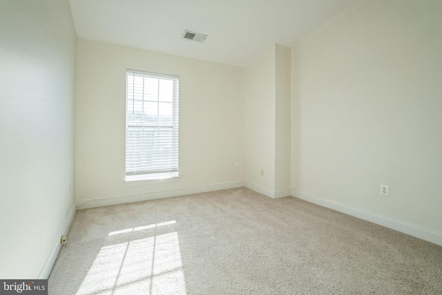 spare room with light colored carpet