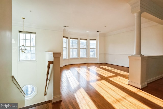 unfurnished living room with light hardwood / wood-style floors and crown molding