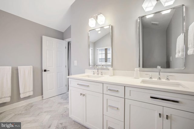 bathroom featuring vanity and vaulted ceiling