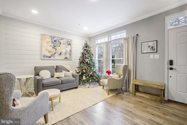 living room with wood-type flooring and crown molding