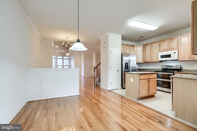 kitchen with decorative light fixtures, light wood-type flooring, light brown cabinetry, and appliances with stainless steel finishes