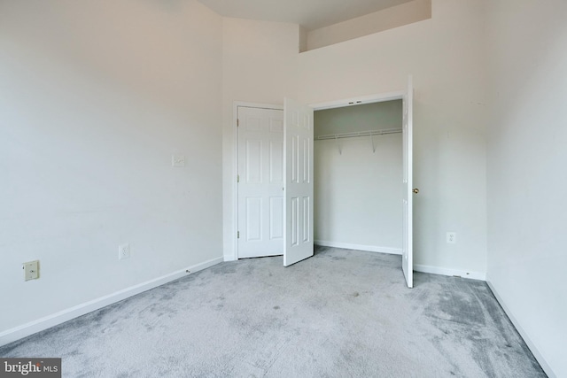 unfurnished bedroom featuring carpet floors and a closet