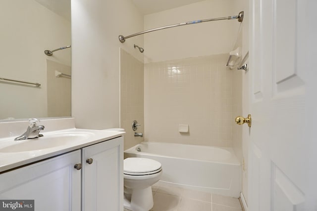 full bathroom with tile patterned flooring, vanity, tiled shower / bath combo, and toilet