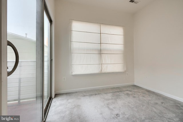 carpeted spare room featuring a wealth of natural light