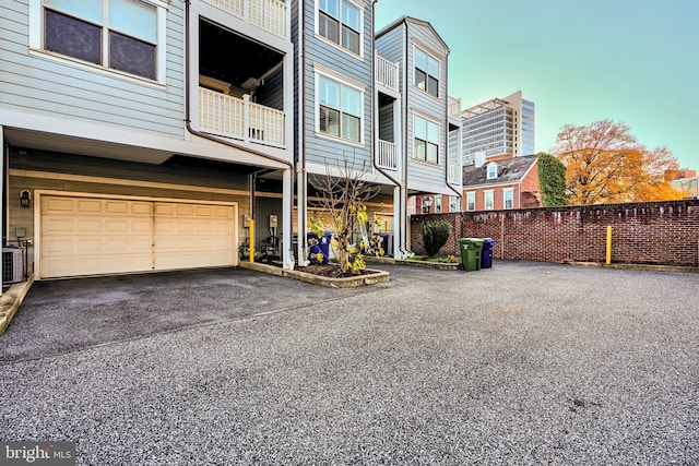 exterior space with central AC and a garage