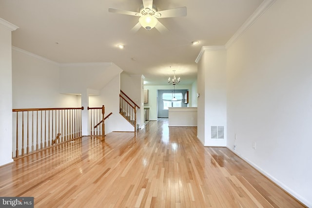 empty room featuring light hardwood / wood-style floors, ceiling fan with notable chandelier, and ornamental molding