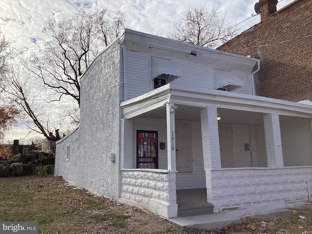 view of property exterior with a porch