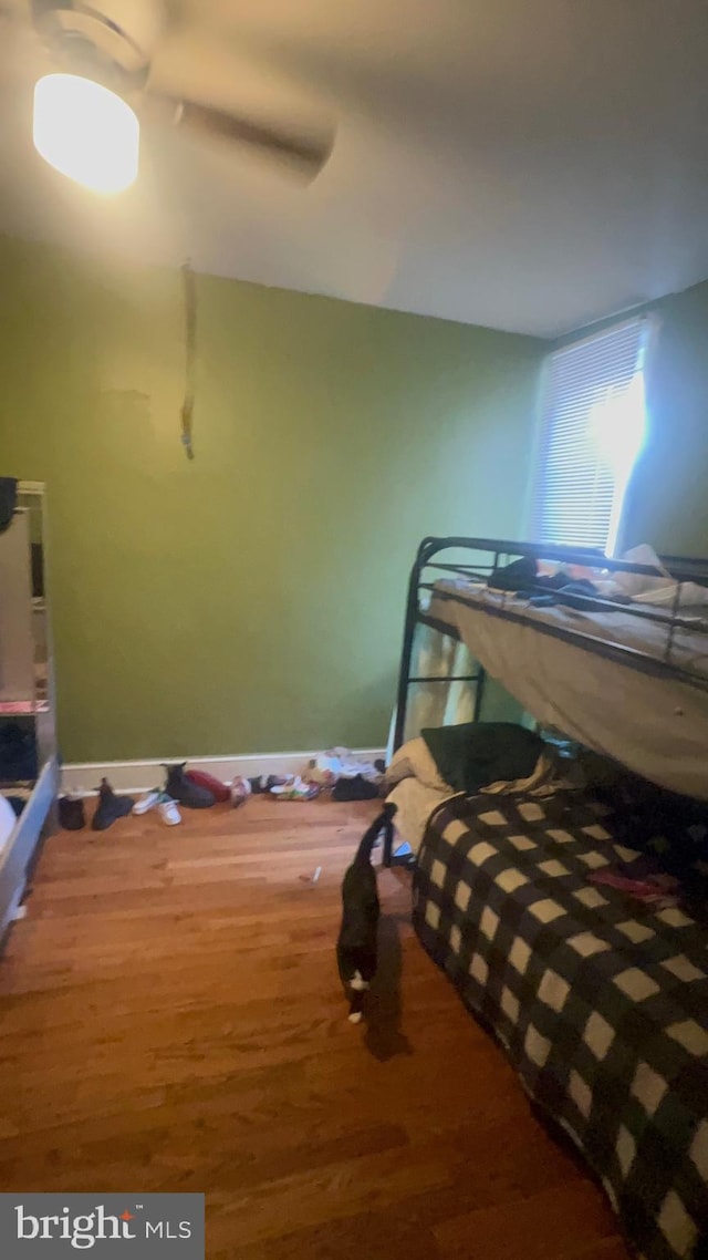 bedroom featuring hardwood / wood-style floors and ceiling fan