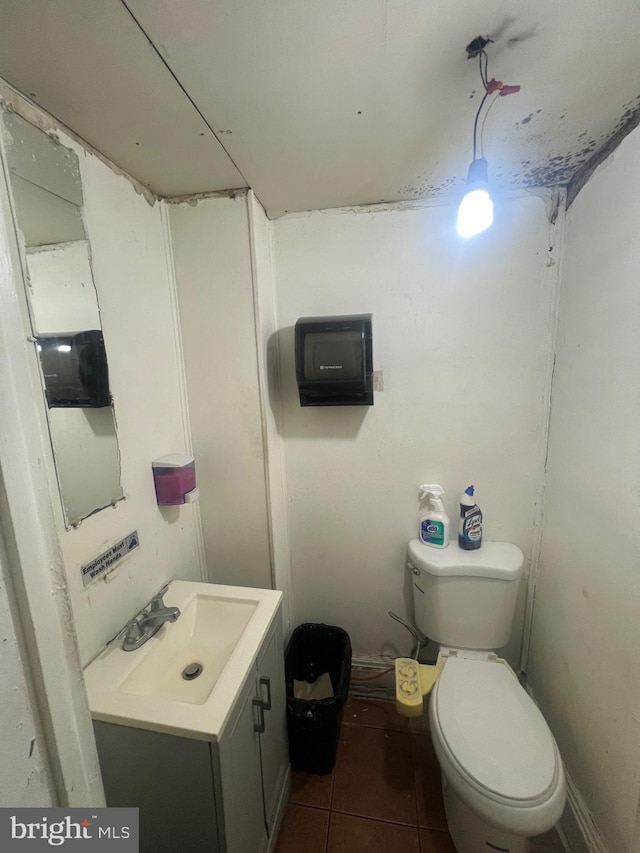 bathroom featuring tile patterned flooring, vanity, and toilet