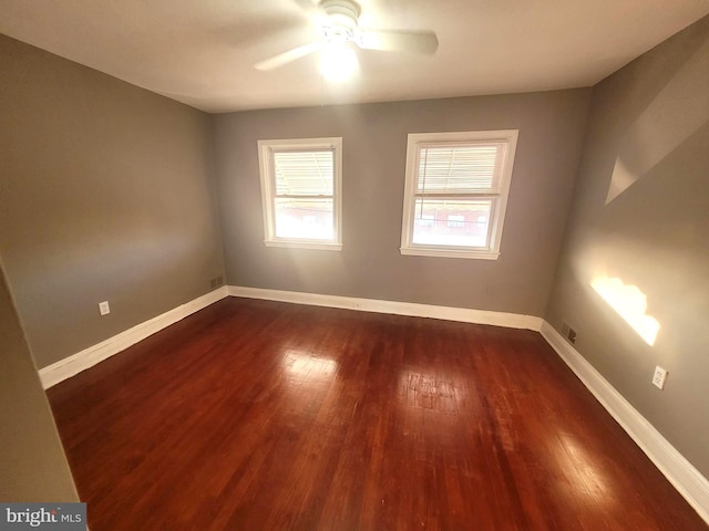 unfurnished room with dark hardwood / wood-style floors and ceiling fan