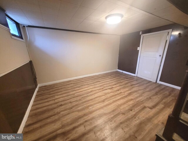 basement with hardwood / wood-style flooring