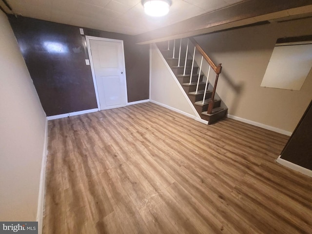 basement with hardwood / wood-style floors