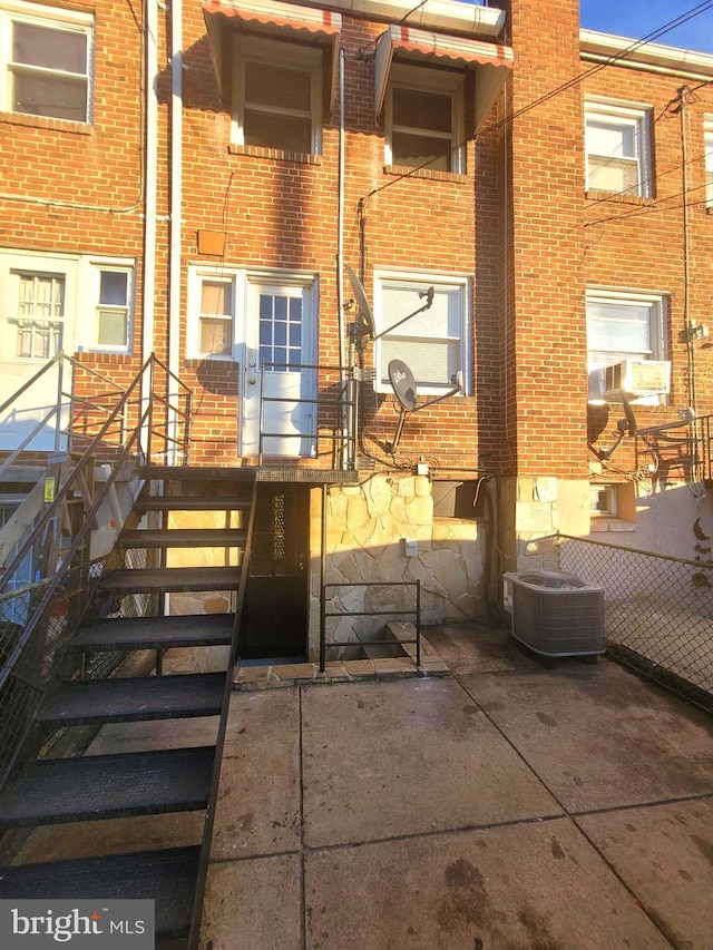 back of property with central AC