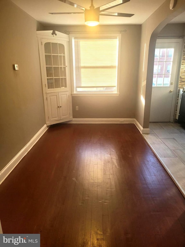 spare room featuring ceiling fan and dark hardwood / wood-style flooring