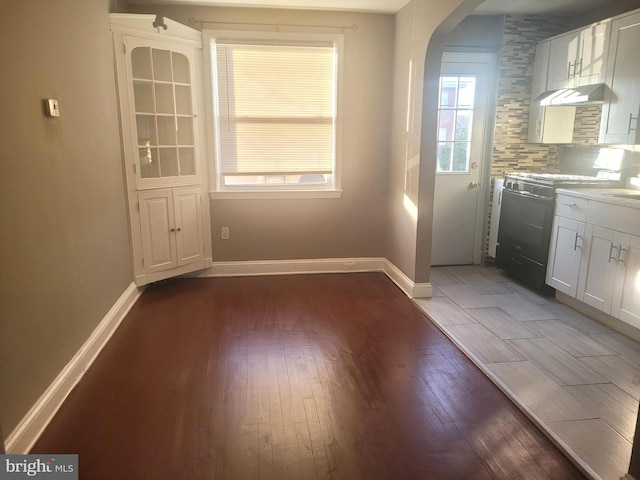 unfurnished dining area featuring dark hardwood / wood-style floors