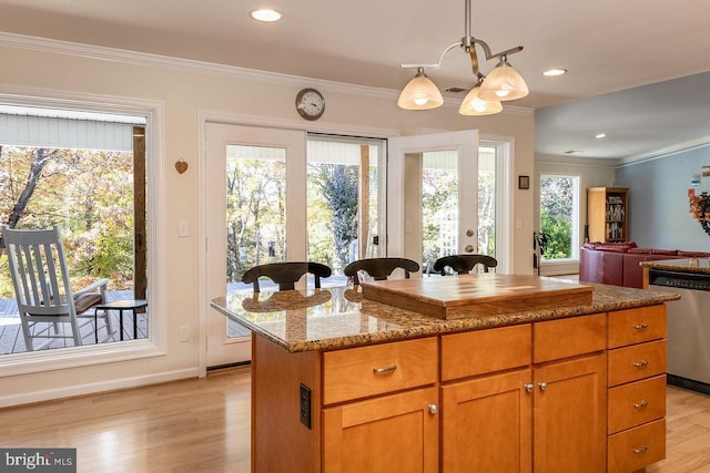 kitchen with dishwasher, light hardwood / wood-style flooring, light stone countertops, decorative light fixtures, and a kitchen island