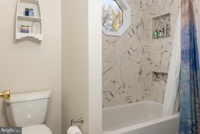 bathroom with shower / tub combo and toilet