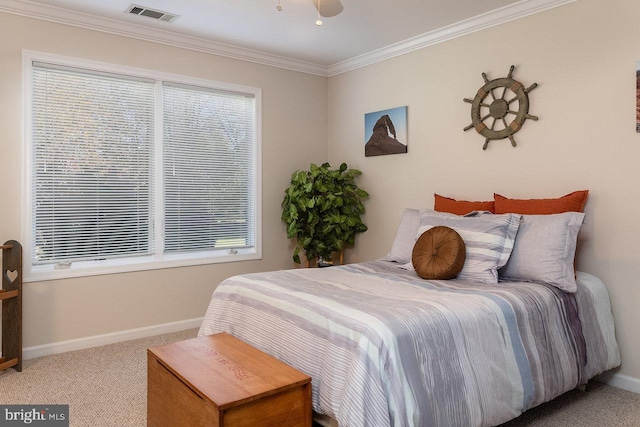 carpeted bedroom with ceiling fan and crown molding