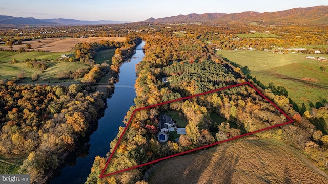 birds eye view of property featuring a water and mountain view