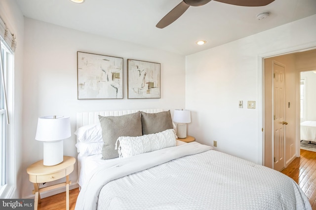 bedroom featuring hardwood / wood-style floors and ceiling fan