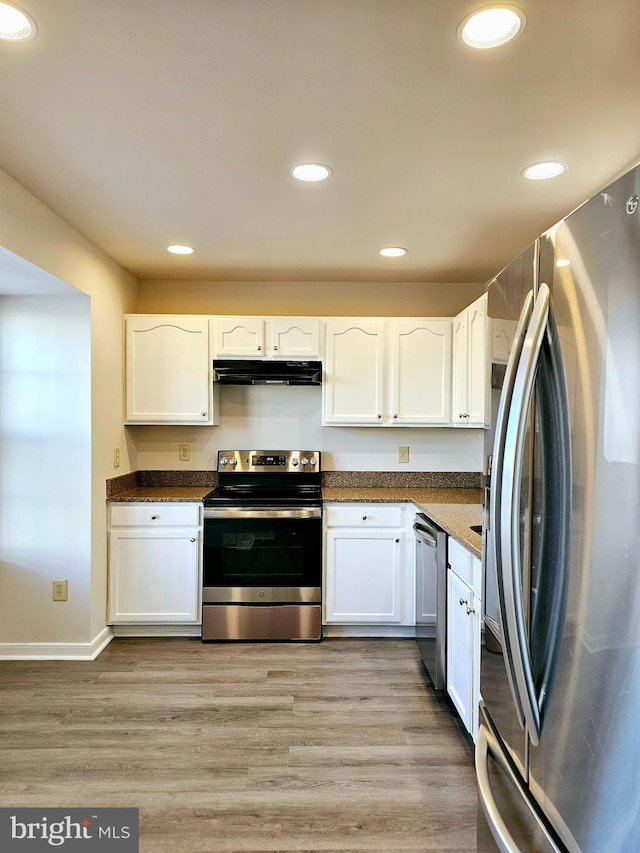 kitchen featuring appliances with stainless steel finishes, light hardwood / wood-style flooring, and white cabinetry