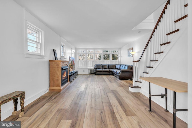 living room featuring light hardwood / wood-style flooring and radiator