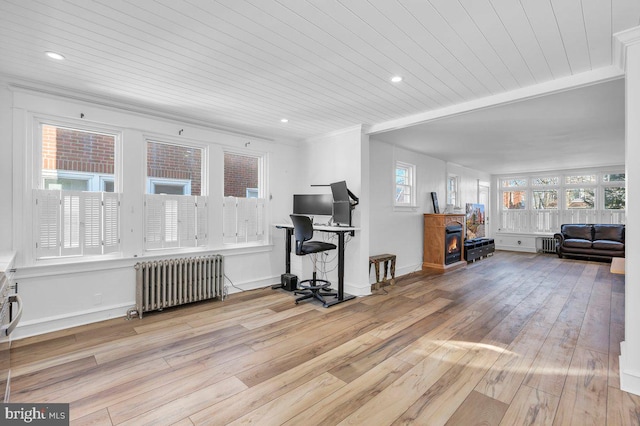 interior space with radiator, ornamental molding, wooden ceiling, and light wood-type flooring