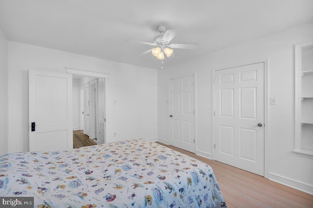 bedroom featuring wood-type flooring and ceiling fan