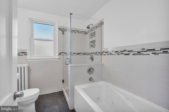 bathroom featuring radiator, tile patterned flooring, toilet, tile walls, and independent shower and bath