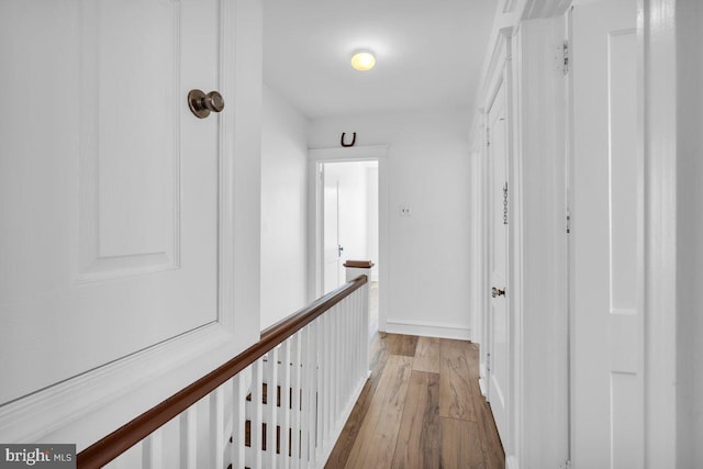 corridor with light hardwood / wood-style flooring