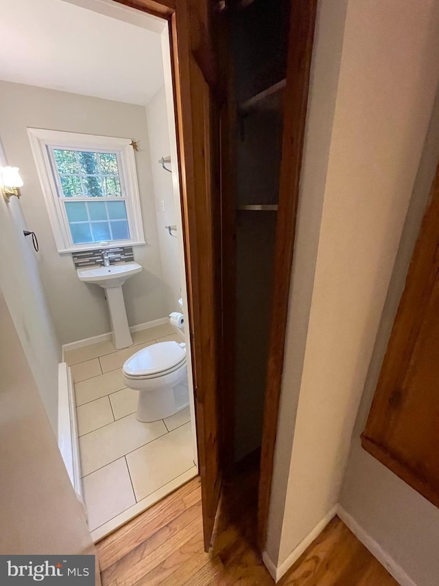 bathroom with toilet and wood-type flooring