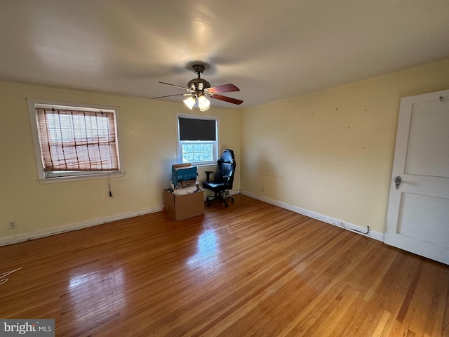 unfurnished office with light hardwood / wood-style flooring, ceiling fan, and a healthy amount of sunlight