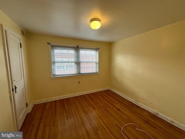 unfurnished room featuring hardwood / wood-style flooring