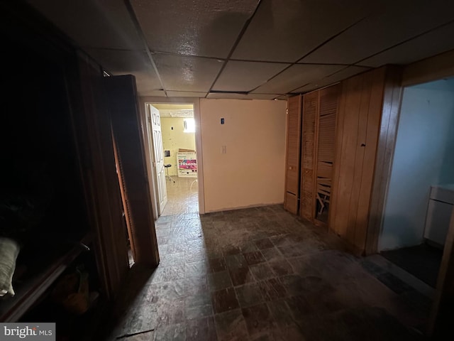 corridor featuring a paneled ceiling