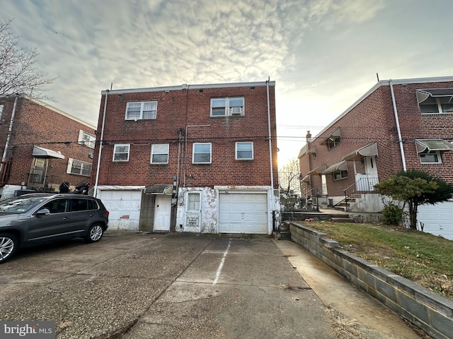 back of property featuring a garage