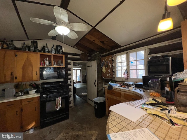 kitchen featuring tile counters, vaulted ceiling, ceiling fan, and black appliances