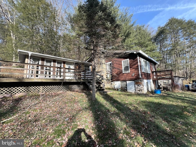 exterior space with a lawn and a wooden deck