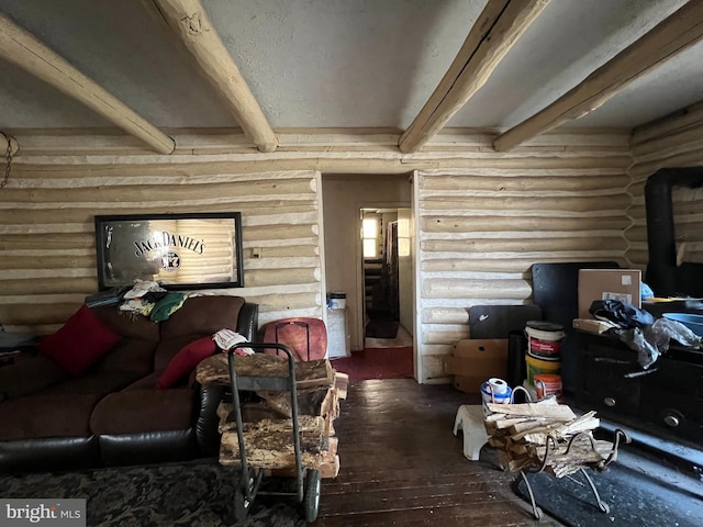 living room featuring beam ceiling, hardwood / wood-style floors, and log walls