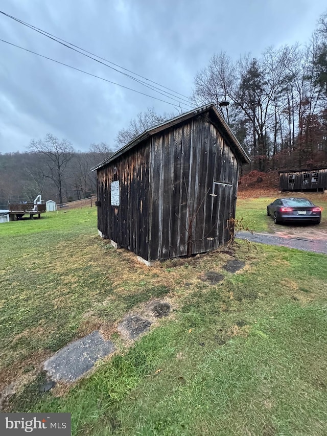 view of outbuilding featuring a yard