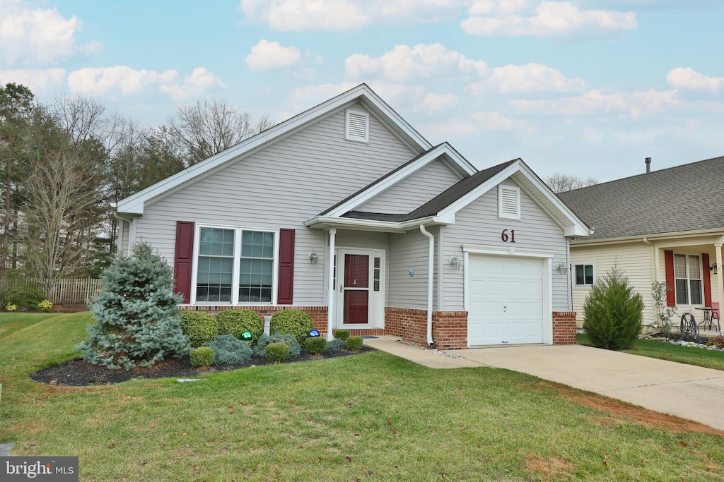 view of front of house with a garage and a front lawn